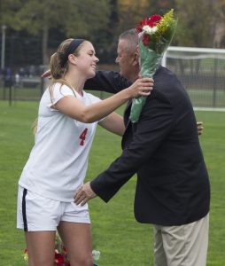 Senior Cassidy Boegel and Head Coach Jim O'Brien hugging during the pre-game ceremony. Alfredo Torres/The Mirror