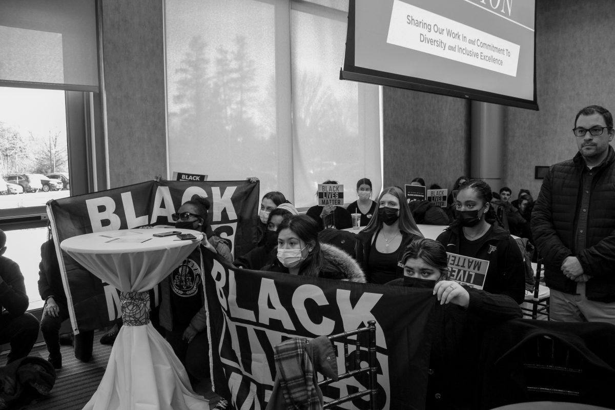 Students kneeling during President Nemec's speech. Photo taken by Kyler Erezuma.