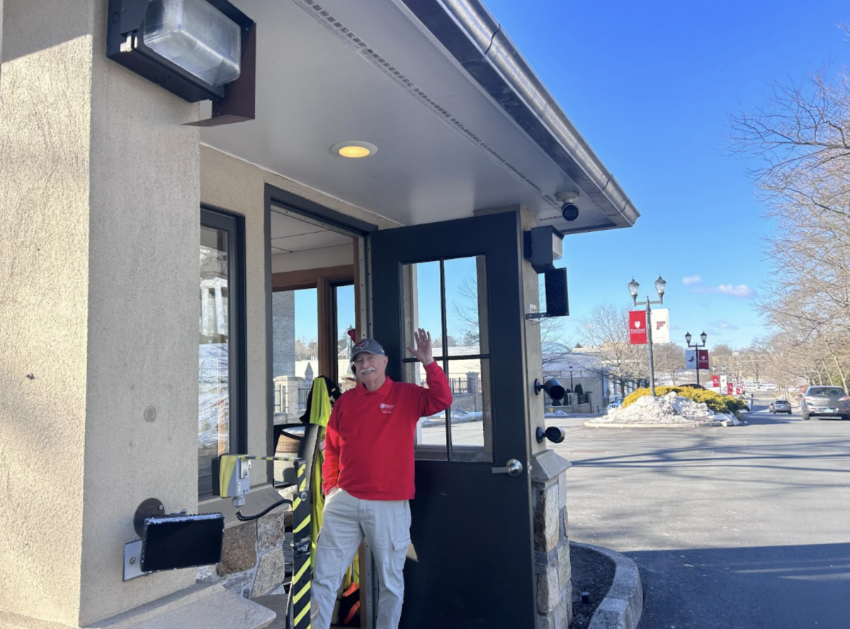 Ralph DeMasi waves as cars drive into Fairfield U. DeMasi along with his colleagues, ensures that everyone who enters campus is met with a welcoming presence.
